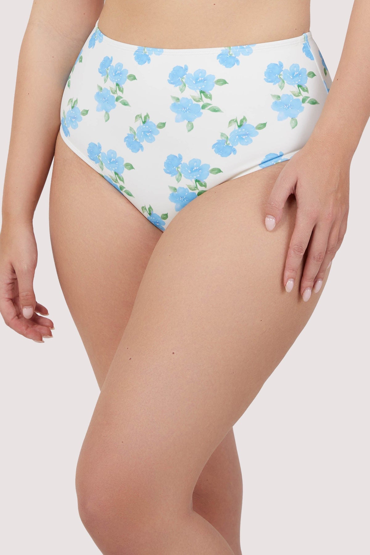 Model wears romantic blue floral high waist bikini bottoms